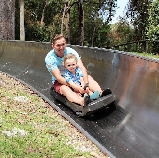 man and girl tobogganing